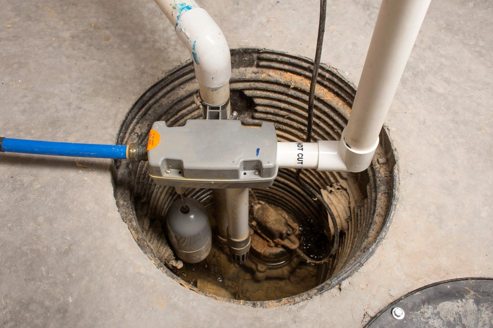 A residential sump pump inside its basin