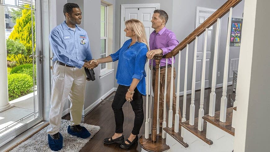 furnace repair technician and family at home