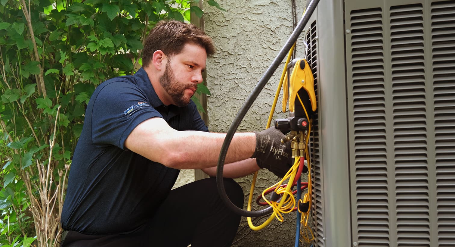 A professional Fenwick Waychoff's HVAC technician inspecting an outdoor central air conditioning unit to provide residential AC repair and diagnostic services.
